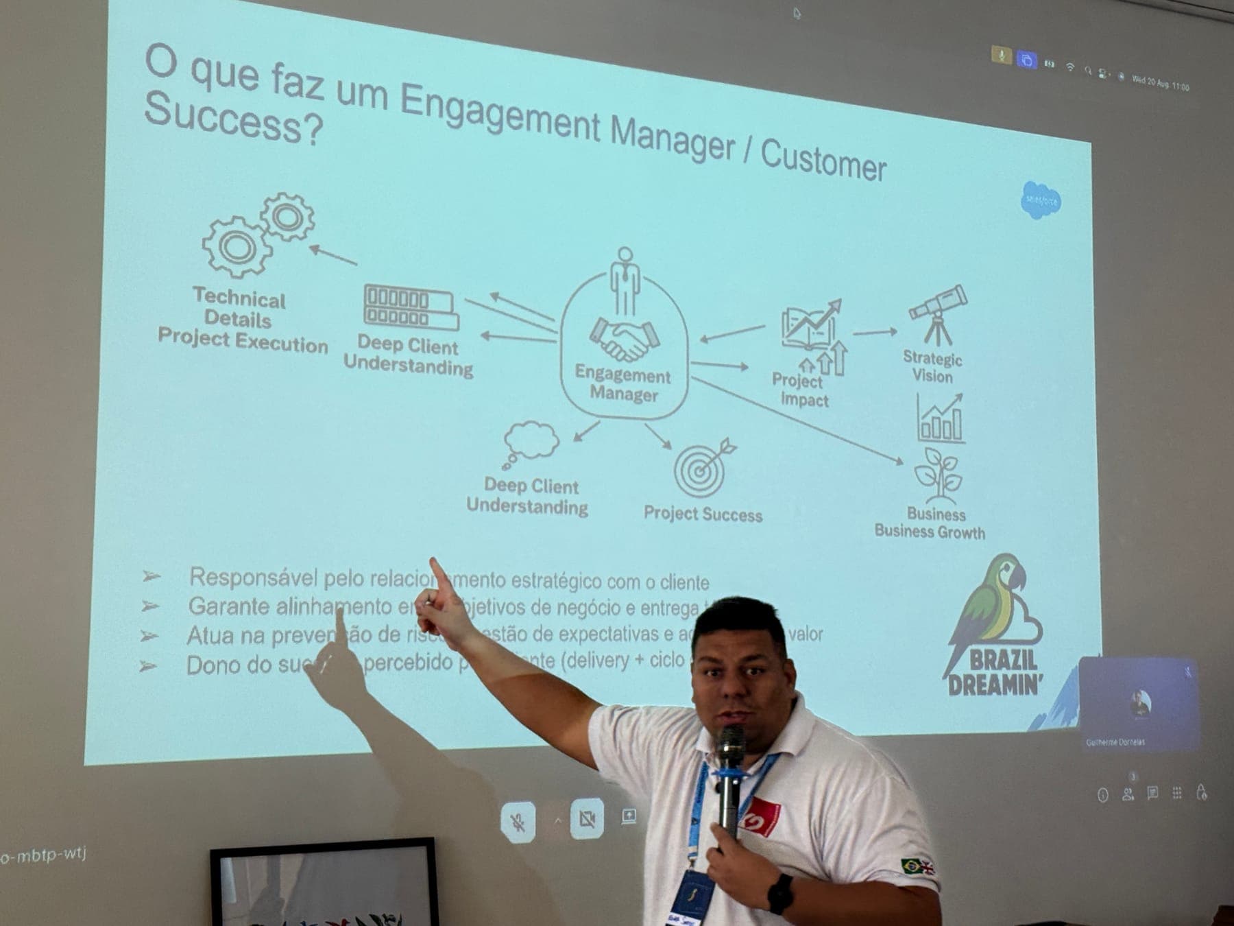 Palestrante aponta um diagrama na projeção